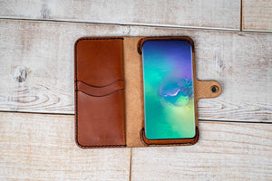 a leather wallet with a phone inside of it