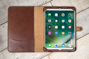 a brown ipad case sitting on top of a wooden table