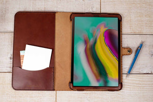 an ipad case with a notepad and pen