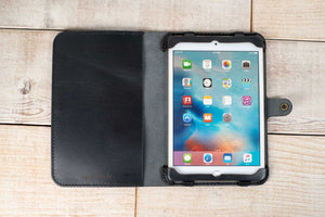 a black ipad case sitting on top of a wooden table